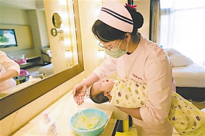 <p>　　母婴护理员在给婴儿洗头。</p>